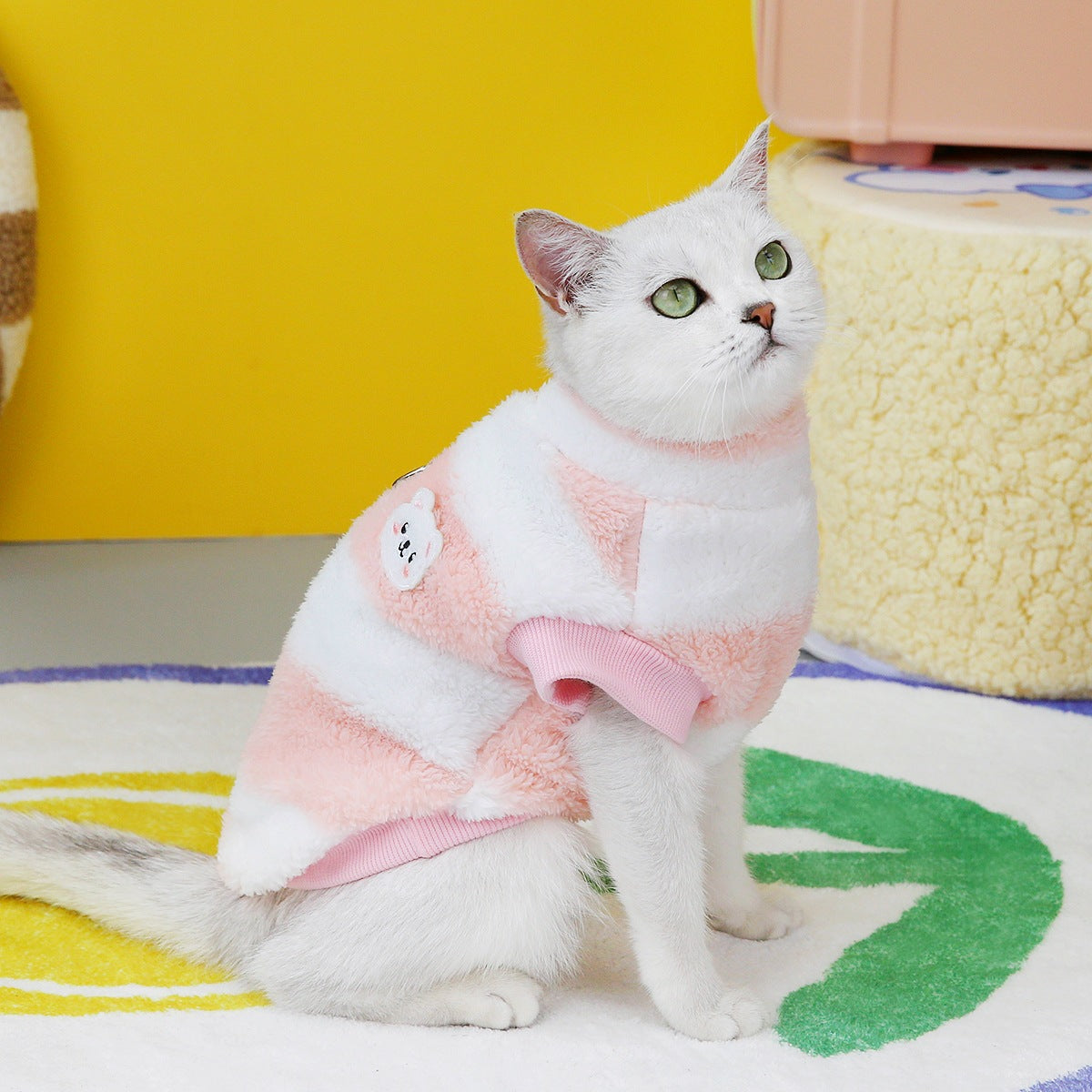 Cat wearing the wine red and pink striped fleece pullover