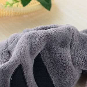 Front view of a small dog wearing the fleece onesie