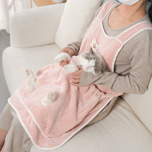 Indoor cat enjoying a supervised cuddle session.