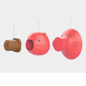 Pink pig suction dog lick toy attached to a smooth wall